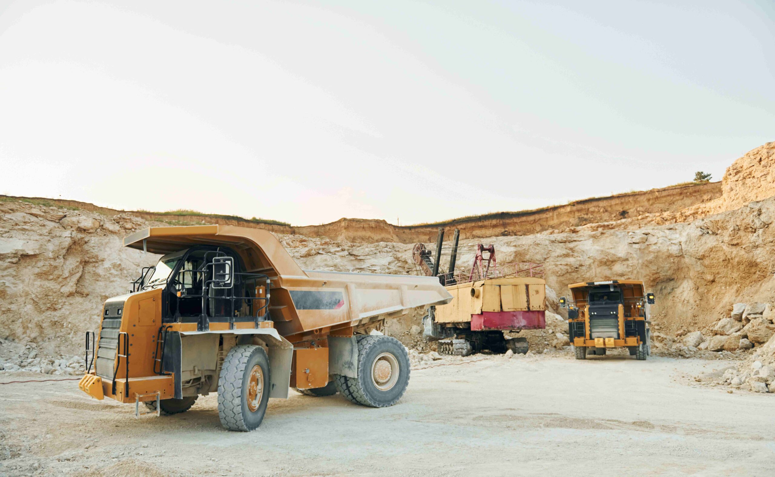 Mining haul trucks operating at a mine site, highlighting the importance of security for mines